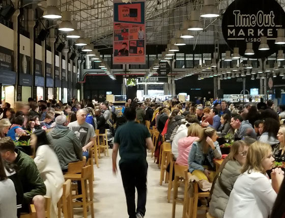 photo of person walking down the aisle at Time Out Market